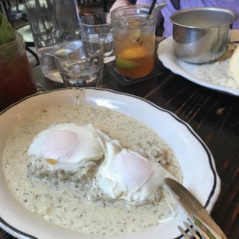 Jacob's Pickles - Biscuit with mushroom sausage gravy and topped with a sunny side eggs - Comfort Food Near Me - New York, New York