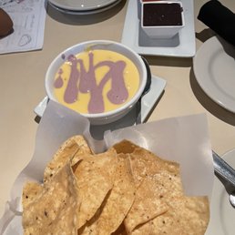 Tasteless queso and not great chips Tasteless queso and not great chips