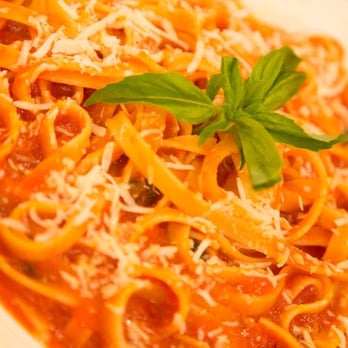 Ponti Rossi - a plate of pasta with cheese and basil - Italian Near Me Ponti Rossi - a plate of pasta with cheese and basil - Italian Near Me