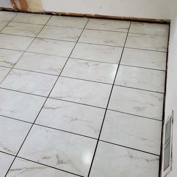 5 Star Construction - a white tile floor in a kitchen - General Contractors Near Me 5 Star Construction - a white tile floor in a kitchen - General Contractors Near Me