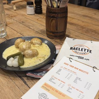 Raclette Factory - Truffle and red wine Raclette with potatoes, pearl onions and pickles. - Swiss Food Near Me - Zürich, ZH Raclette Factory - Truffle and red wine Raclette with potatoes, pearl onions and pickles. - Swiss Food Near Me - Zürich, ZH
