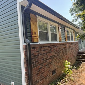 LV Building Solutions - Cedar window shutters over forest green D5 dutch lap vinyl siding with bronze gutter work - General Contractors Near Me LV Building Solutions - Cedar window shutters over forest green D5 dutch lap vinyl siding with bronze gutter work - General Contractors Near Me