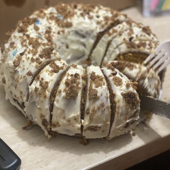 DeeLee Cakes - a cake with white frosting and brown sprinkles - Desserts Near Me