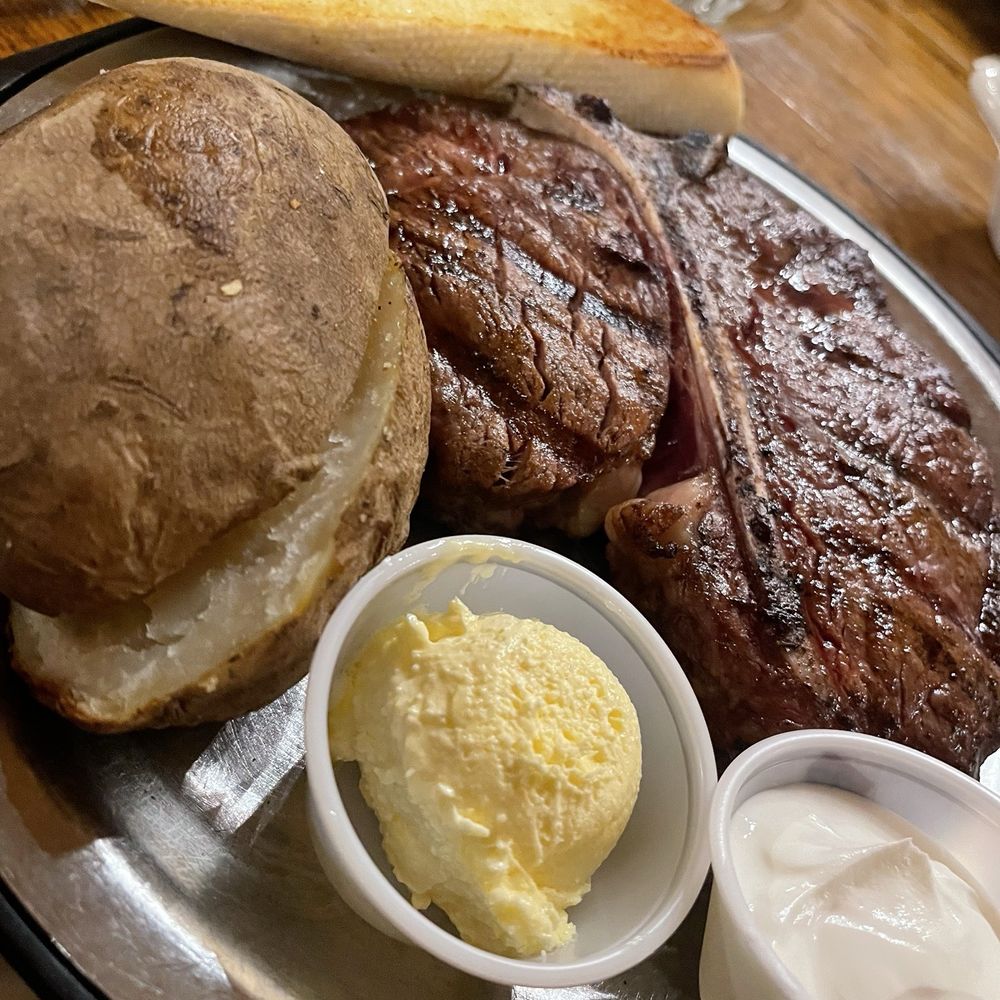 The huge porterhouse and potato The huge porterhouse and potato