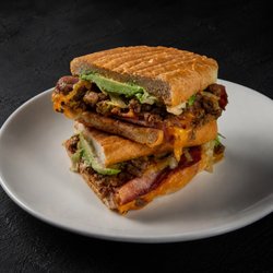 Fuego Cravings - La California is packed with asada, beans, crispy bacon, ham, panela cheese, tomato, lettuce, onion, avocado & our signature FC spread.