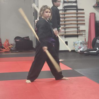 Key Martial Arts - My daughter in weapons class practicing with a Bo Staff - Karate Near Me - Oceanside, California Key Martial Arts - My daughter in weapons class practicing with a Bo Staff - Karate Near Me - Oceanside, California