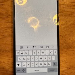 AT&T Store - Photo showing that the screen protector is not cracked from my actions, but crooked due to AT&T's bad attempt at putting it on.