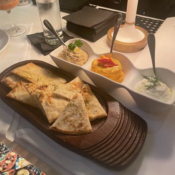Avra - Three dip sampler with eggplant, spicy feta and tzatziki. - Greek Near Me - Dallas, Texas Avra - Three dip sampler with eggplant, spicy feta and tzatziki. - Greek Near Me - Dallas, Texas