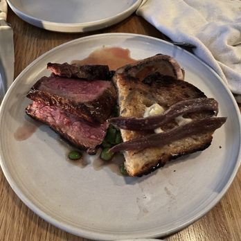 Lawrence - Aged NY strip, fava beans, peas, bone marrow and anchovy toast - Modern European Near Me - Montreal, Quebec