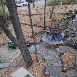 Low Maintenance Landscape - Stone patio, water garden and seatwall