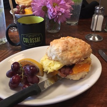 Colossal Cafe - Egg, Cheddar, and Bacon sandwich. So simple but the homemade biscuit is the best!! - American Near Me - Saint Paul, Minnesota Colossal Cafe - Egg, Cheddar, and Bacon sandwich. So simple but the homemade biscuit is the best!! - American Near Me - Saint Paul, Minnesota