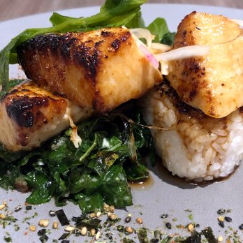 Basalt - Kasu Marinated Alaskan Black Cod w/ Onigiri (rice ball), sautéed local greens, chili oil, and soy-mirin glaze - New American Near Me - Honolulu, Hawaii Basalt - Kasu Marinated Alaskan Black Cod w/ Onigiri (rice ball), sautéed local greens, chili oil, and soy-mirin glaze - New American Near Me - Honolulu, Hawaii