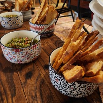 Focacciaza - a wooden table with bowls of food - Italian Near Me - Vancouver, British Columbia Focacciaza - a wooden table with bowls of food - Italian Near Me - Vancouver, British Columbia