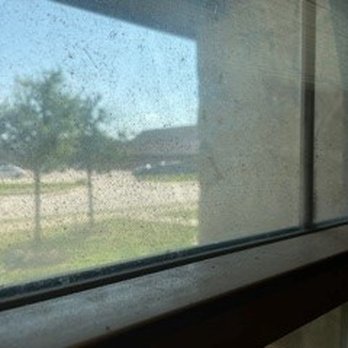 The Barracks Townhomes - interior window so black with dirt you could hardly see out of it - Property Management Near Me - College Station, Texas