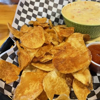 Sawmill Grille & Spirits - Homemade chips (to die for) and cheese queso blanco w/side of sriracha YUMMM! - American Near Me - Post Falls, Idaho Sawmill Grille & Spirits - Homemade chips (to die for) and cheese queso blanco w/side of sriracha YUMMM! - American Near Me - Post Falls, Idaho