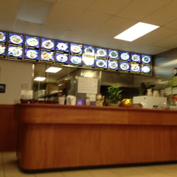 China One - a restaurant counter with a lot of plates on the wall - Chinese Near Me - Newnan, Georgia