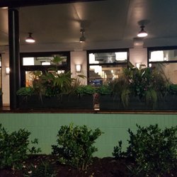 Poogan's Southern Kitchen - Outdoor dinning set apart with huge planters