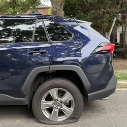 Toyota RAV4 with a flat tire in need of a tire change.