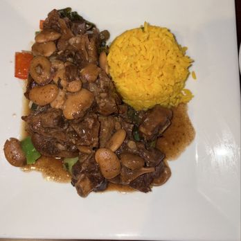 Palm Grill - Slow-Braised Island Oxtail with yellow rice - New American Near Me - Valley Stream, New York Palm Grill - Slow-Braised Island Oxtail with yellow rice - New American Near Me - Valley Stream, New York
