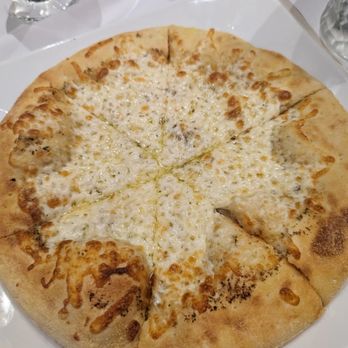 Ottavio - a cheese pizza on a white plate - Pizza Near Me - Montreal, Quebec Ottavio - a cheese pizza on a white plate - Pizza Near Me - Montreal, Quebec