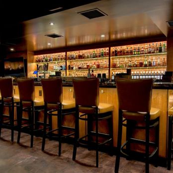 Slow Burn Lounge Dover - a bar with a row of bar stools - Speakeasies Near Me - Dover, New Hampshire Slow Burn Lounge Dover - a bar with a row of bar stools - Speakeasies Near Me - Dover, New Hampshire