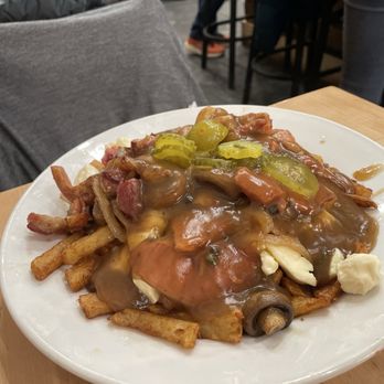 Chez Claudette - Poutine Celine (mushrooms, cornichons, sausages) - Poutineries Near Me - Montreal, Quebec Chez Claudette - Poutine Celine (mushrooms, cornichons, sausages) - Poutineries Near Me - Montreal, Quebec