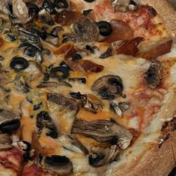 Macy’s Place Pizzeria - Plant based cheese, pepperoni, black olives and mushrooms.
