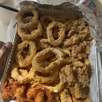 Tummy Time Fish & Chicken - This is the seafood platter with calamari and oysters perfectly seasoned and fried. - Seafood Near Me - Jacksonville, Florida Tummy Time Fish & Chicken - This is the seafood platter with calamari and oysters perfectly seasoned and fried. - Seafood Near Me - Jacksonville, Florida