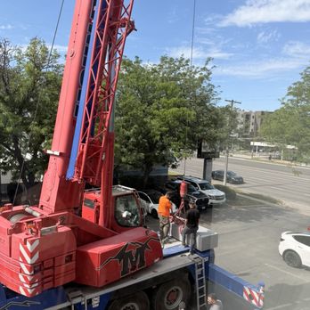 All Around Cooling & Heating - The team working with the crane to lift equipment onto the roof. - Heating & Air Conditioning/HVAC Near Me