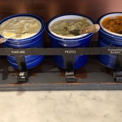 Pacini - These are the different butters translated from French:  garlic, regular, pesto, and tomato basil.  I had toasted bread with the last two.