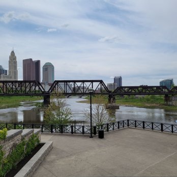 North Bank Park - Skyline, river,  and glimpse of umbrella tables to the right. - Parks Near Me - Columbus, Ohio
