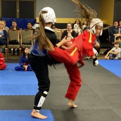Total Impact Martial Arts - Students sparring with a back kick
