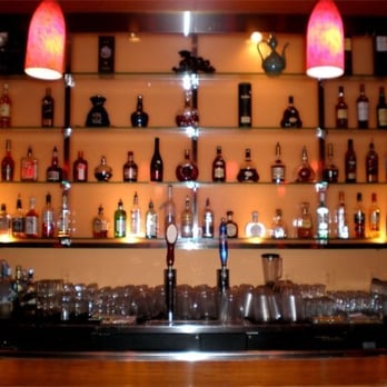 Cafe Sole - a bar with a lot of bottles on the shelves - Karaoke Near Me - Annandale, Virginia