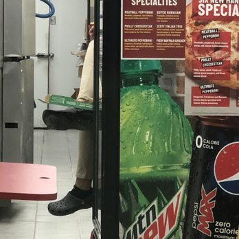 Papa Johns Pizza - Papa John's worker sitting up on the counter with her feet by a pizza box - Pizza Near Me - Marathon, Florida Papa Johns Pizza - Papa John's worker sitting up on the counter with her feet by a pizza box - Pizza Near Me - Marathon, Florida