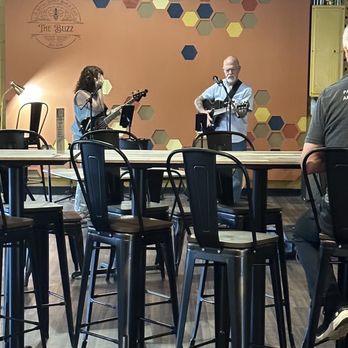 The Buzz - a group of people sitting at tables in a restaurant - Coffee & Tea Near Me - Hendersonville, North Carolina