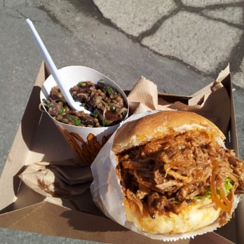 Pas D'cochon Dans Mon Salon - a pulled pork sandwich and a bowl of salad - Food Trucks Near Me Pas D'cochon Dans Mon Salon - a pulled pork sandwich and a bowl of salad - Food Trucks Near Me