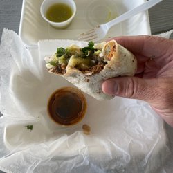 Tacos Gonzalez - Gonzalez burrito spicy pork and Kearny Asada. With green sauce and a smoked chili sauce.
