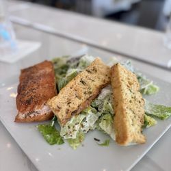 Pan seared salmon over little gem lettuce with Caesar dressing,