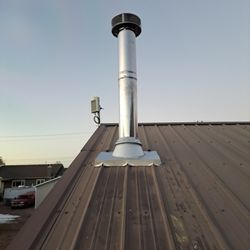 Capital Chimney Service - Metal roof flashing on wood stove Chimney install