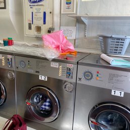 Washing machines and soap dispenser up top. £8 to £10 per washing run plus about £2 for 16 minutes of high heat drying. Washing machines and soap dispenser up top. £8 to £10 per washing run plus about £2 for 16 minutes of high heat drying.
