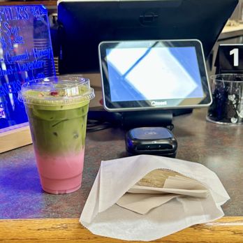 Conejo Coffee - Matcha rose latte(iced) w/almond milk and a crème brûlée bar to go - Coffee & Tea Near Me - Newbury Park, California Conejo Coffee - Matcha rose latte(iced) w/almond milk and a crème brûlée bar to go - Coffee & Tea Near Me - Newbury Park, California