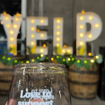 Revision Brewing - a hand holding a wine glass - Breweries Near Me - Sparks, Nevada