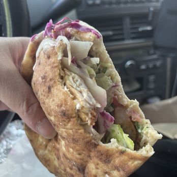 Duzan - Two bites in Chicken Kabab Pita to show inside - Middle Eastern Near Me - Queens, New York