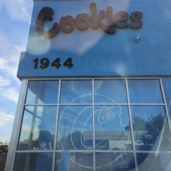 Cookies Modesto Dispensary - Cookies dispensary storefront with the address 1944 and a moon logo on the glass window, taken during daytime with a clear sky. - Cannabis Dispensaries Near Me - Modesto, California