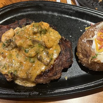 Outback Steakhouse - Bone-In Ribeye* 18 oz. With the shrimp and mushroom sauce. Dressed Baked Potato - Steakhouses Near Me - Lewisville, Texas