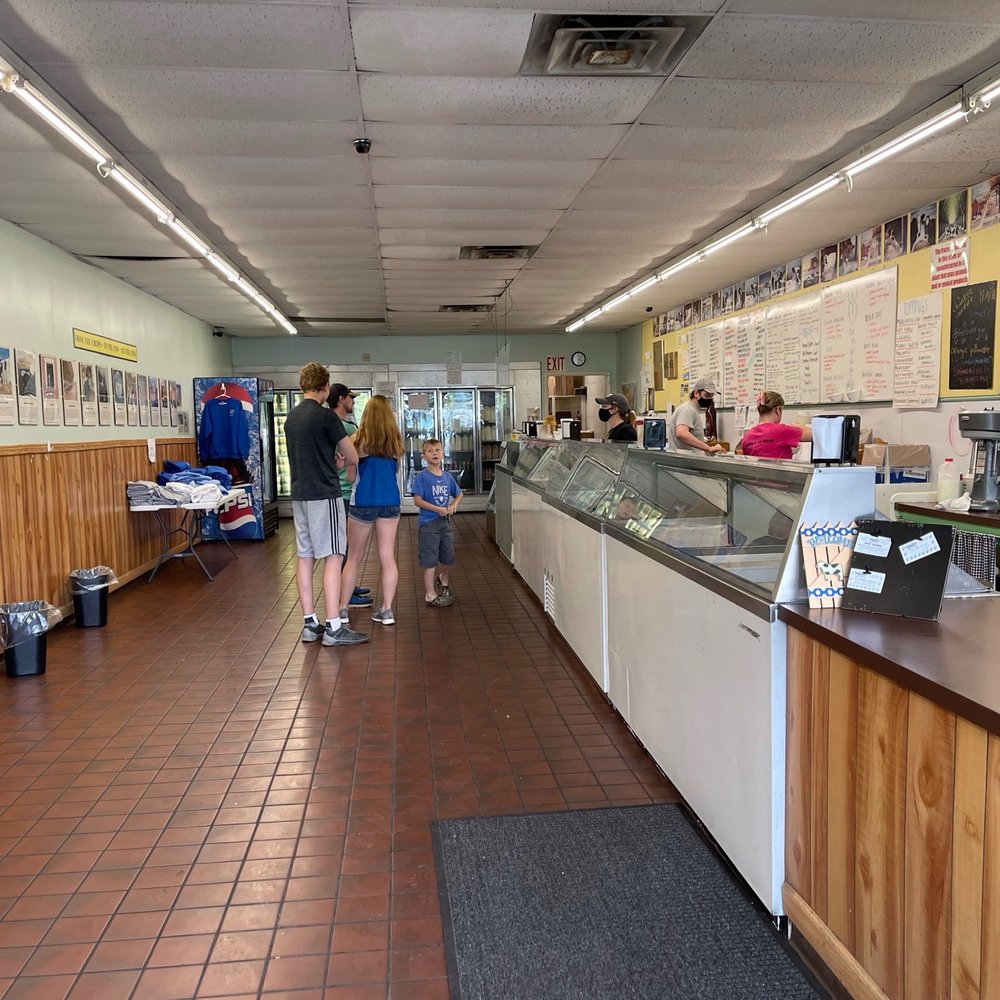 Manning Farm Dairy - Long row of freezers with ice cream for scooping and history and info along the wall. - Ice Cream & Frozen Yogurt Near Me - Dalton, Pennsylvania Manning Farm Dairy - Long row of freezers with ice cream for scooping and history and info along the wall. - Ice Cream & Frozen Yogurt Near Me - Dalton, Pennsylvania
