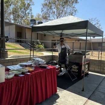The Taco Guy Catering - David serving us in the blistering heat! The set up was perfect and had all the sides. - Caterers Near Me - Pasadena, California The Taco Guy Catering - David serving us in the blistering heat! The set up was perfect and had all the sides. - Caterers Near Me - Pasadena, California