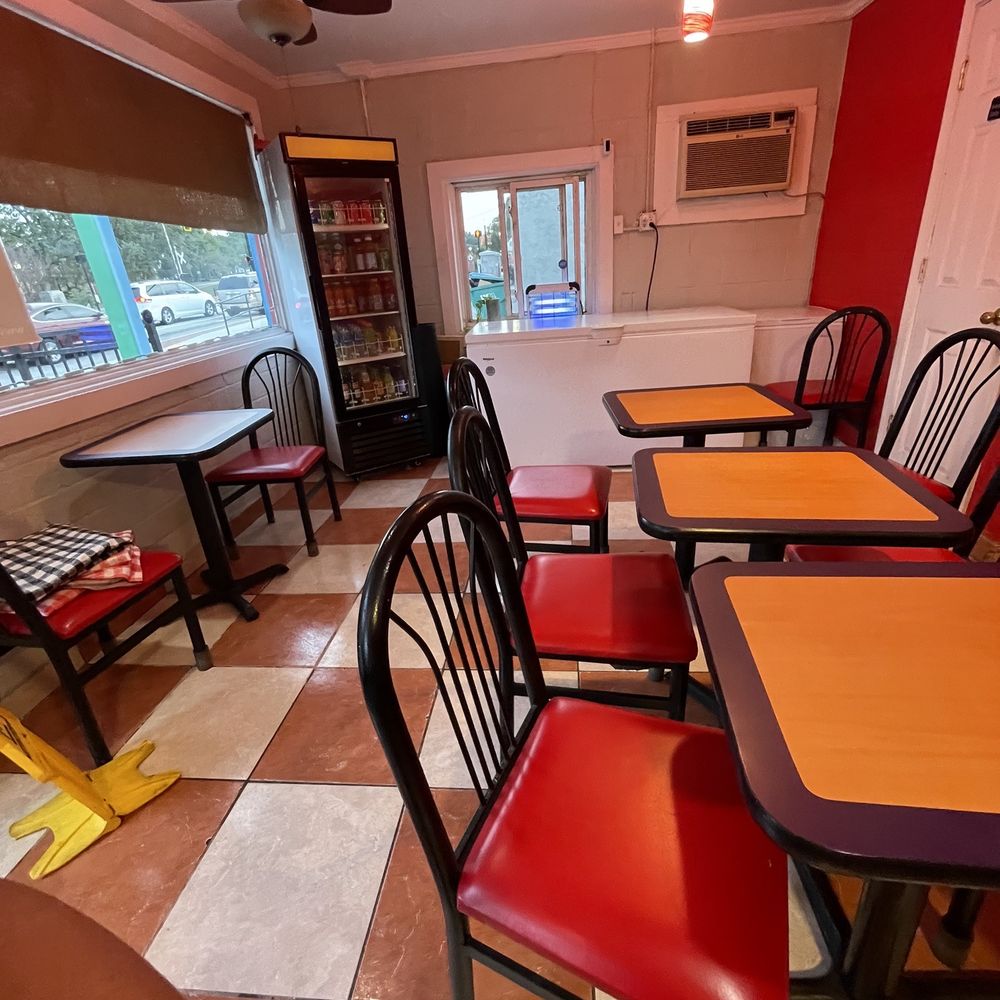 a dinning room with red chairs a dinning room with red chairs