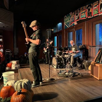Friends Bar - a man playing a guitar on stage - Music Venues Near Me - Austin, Texas Friends Bar - a man playing a guitar on stage - Music Venues Near Me - Austin, Texas
