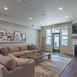 Sandyplace Apartment Homes - A living room with a fireplace and a couch.
